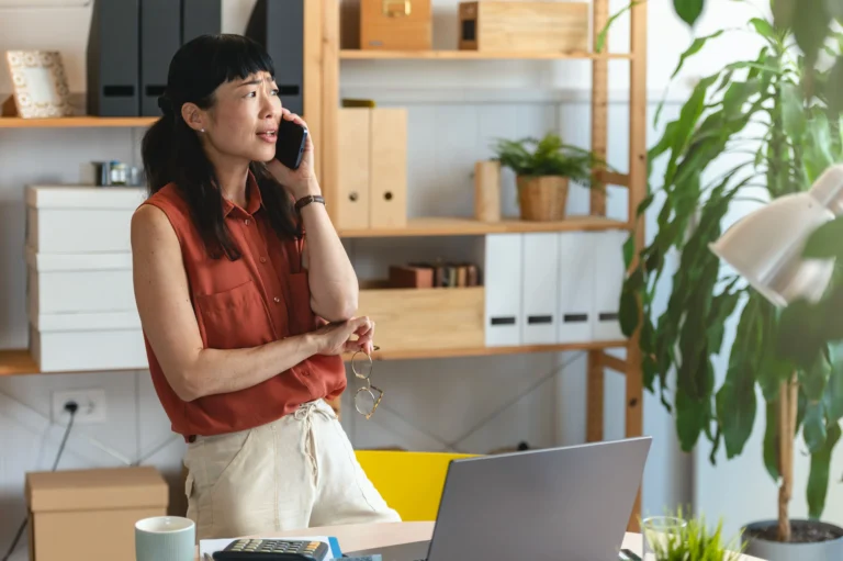 Woman having a phone conversation while working from home